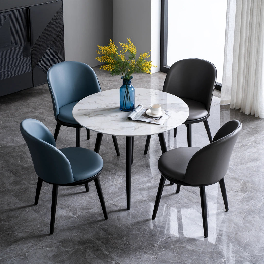 White dining set with round marble-patterned table and four matching chairs, featuring a stylish faux marble finish.